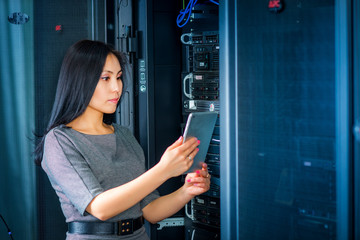 Engineer businesswoman in network server room