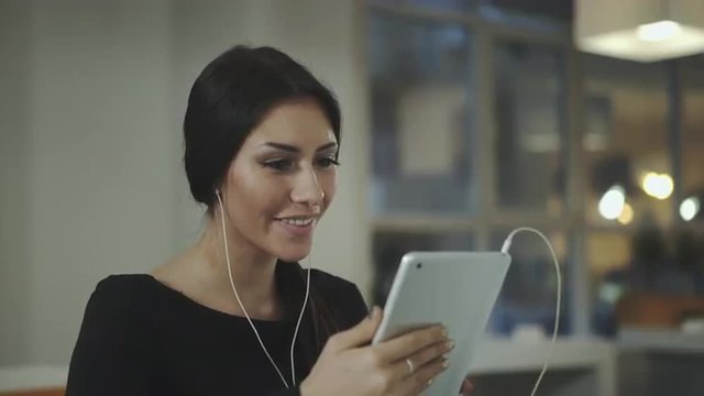 A woman in the office talking with a tablet