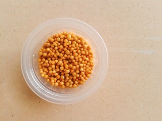 brown fertilizer pellets on wood plank