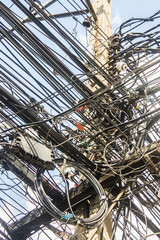 Obraz premium Disorganized, Messy electrical cables in Thailand