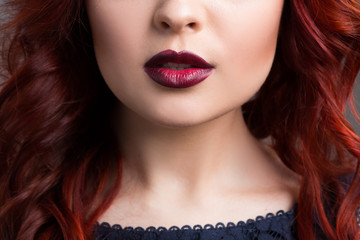 closeup cherry lips. girl with red hair. the lower part of the face. Fashion Girl Portrait