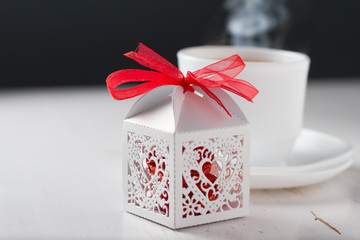 Present in white box and hot steaming tea