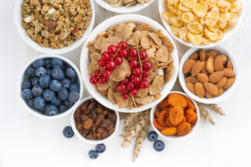 assortment of different breakfast cereal, dried fruit 