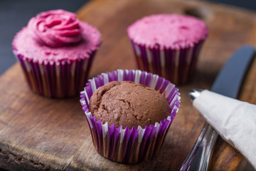 Decorating chocolate cupcakes with buttercream