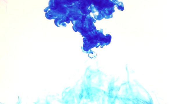 blue color dissolving in clear water against white background