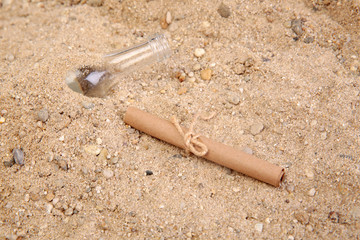 paper message from a bottle in sand