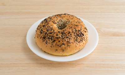 Every seasoning bagel on a white plate