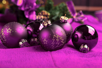 Violet christmas balls on violet background