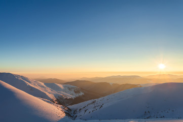 Sunset landscape. Evening glow in winter mountains.