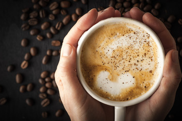 Cup of cappuccino in the hand