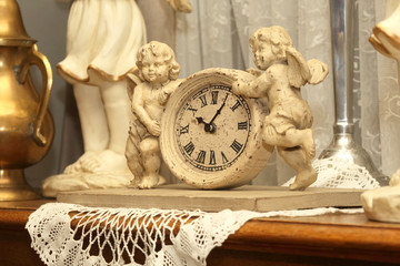 antique clock with two figures of angels