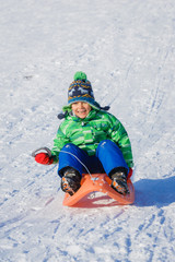 Fototapeta na wymiar Boy enjoying a sleigh ride. 