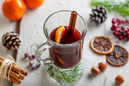 Glass of mulled wine with citrus fruits and cinnamon.