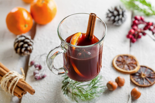 Traditional holiday winter hot drink. Mulled wine on snow covered table.