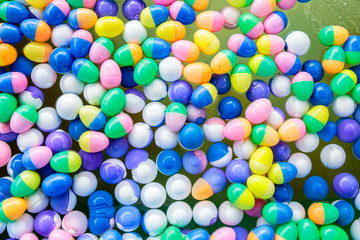 Colorful of lucky balls or eggs floated in water for gamble.