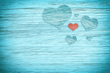 Wooden hearts on blue background