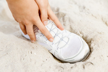 Fototapeta premium Runner laces his shoes and prepares to jogging