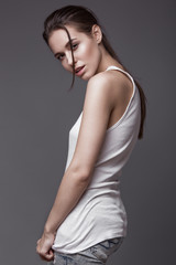 Fototapeta premium sexy fashion model with long hair, young European attractive, beautiful eyes, perfect skin is posing in studio for glamour vogue test photo shoot showing different poses