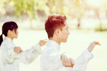 Handsome man practicing thai chi