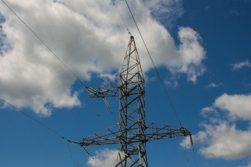high voltage power pylon in cloudy sky