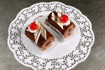 sweet chocolate cake with cherries on a gray background
