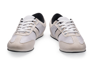 A pair of white sports shoes with shoelace