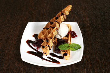 cakes with fruit sauce and ice cream on a white plate