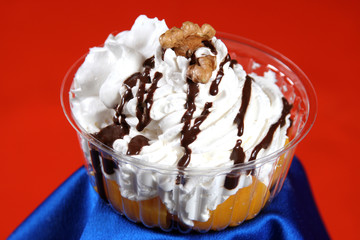 dessert of ice cream and cream covered in chocolate with nuts an