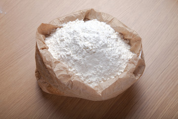 Flour on light wooden table like background. Selective focus