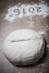 Figures 2016 on a flour on a light wooden table. Selective focus