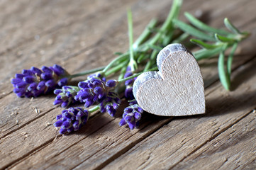 Bunsh of lavender flowers and a wooden heart
