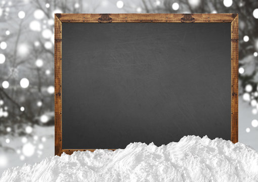 Blank blackboard with blurr forest and snow