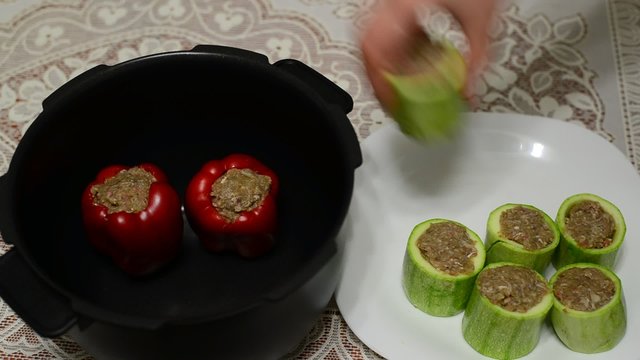 Woman prepares stuffed vegetables in Multicooker 