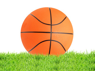 Basketball ball in green grass isolated on white