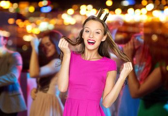 happy young woman or teen girl in pink dress