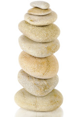 Balanced stack of different stones on white background