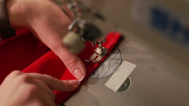 Woman working with sewing machine. Sewing machine showing process. Close up.