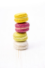 Sweet and colourful french macaroons on retro-vintage wood
