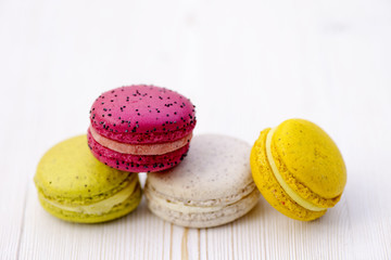 Sweet and colourful french macaroons on retro-vintage wood