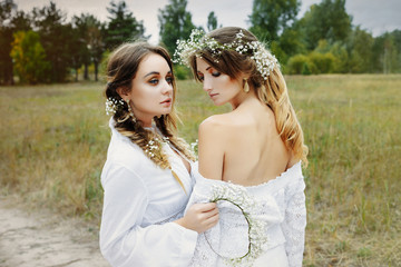 Fototapeta premium Two women in white dresses