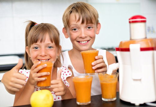 Cute Kids Making Carrot And Apple Juice With A Juice Extractor