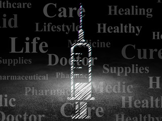 Medicine concept: Syringe in grunge dark room