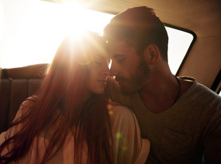 Romantic young couple in car