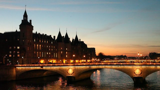 silhouette of Conciergerie and night lights of Paris