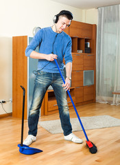 Happy guy    with dustpan and brush