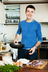 Guy cooking squid rings