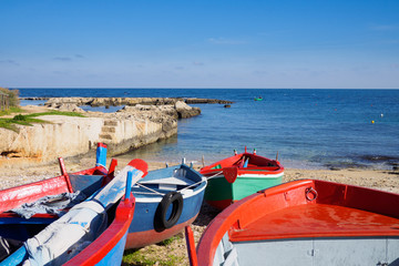 Fototapeta na wymiar Small fishing boats docked in the harbor of Polignano a Mare - Apulia, Italy