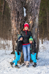 Fototapeta na wymiar Happy family in the winter forest.