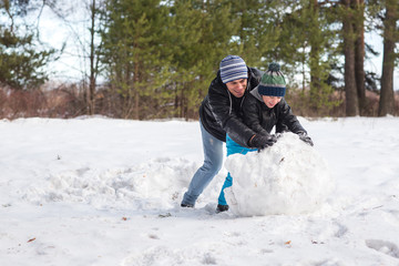 Fototapeta na wymiar Dad and son playing in snow