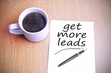 Coffee on the table with note writing get more leads